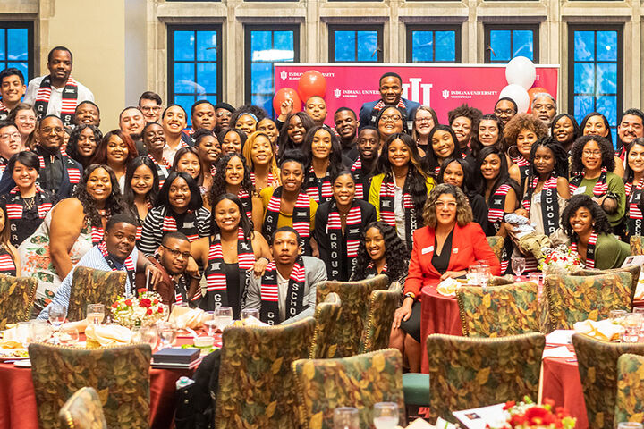 Groups Scholars pose together at a banquet
